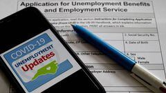 (FILES) In this file photo illustration taken on May 8, 2020, Unemployment Assistance Updates logo is displayed on a smartphone on top of an application for unemployment benefits in Arlington, Virginia. - Another 2.43 million US workers were put out of wo