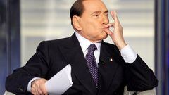 FILE PHOTO: Italy's former Prime Minister Silvio Berlusconi gestures as he appears as a guest on the RAI television show Porta a Porta (Door to Door) in Rome, Italy, January 9, 2013.  REUTERS/Remo Casilli/File Photo