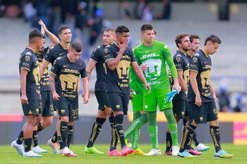 Players of Pumas react after losing the 12th round match 