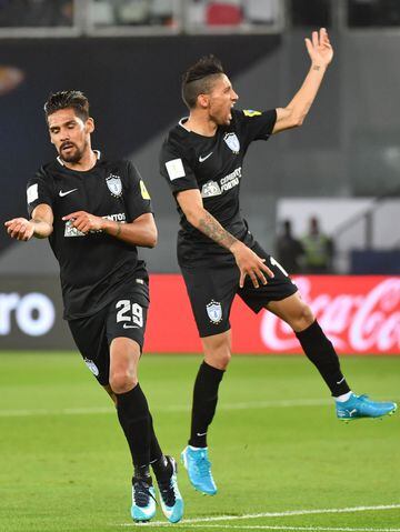 CF Pachuca's Argentinian forward Franco Jara (L) celebrates with his Uruguayan teammate Jonathan Urretaviscaya after scoring a goal during the third place football match of the FIFA Club World Cup UAE 2017 between Al-Jazira and CF Pachuca at the Bin Zayed