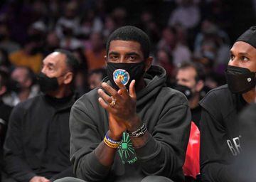 Kyrie Irving #11 of the Brooklyn Nets cheers from the bench during a preseason game against the Los Angeles Lakers at Staples Center in Los Angeles, California on October 02, 2021.