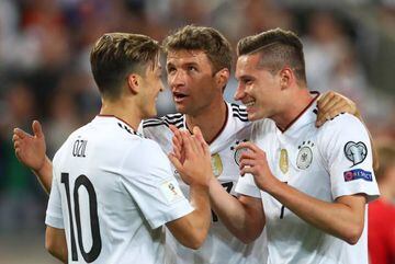 Julian Draxler of Germany (r) is being celebrated by Mesut Oezil and Thomas Mueller.