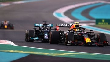 ABU DHABI, UNITED ARAB EMIRATES - DECEMBER 12: Sergio Perez of Mexico driving the (11) Red Bull Racing RB16B Honda leads Lewis Hamilton of Great Britain driving the (44) Mercedes AMG Petronas F1 Team Mercedes W12 with Max Verstappen of the Netherlands dri