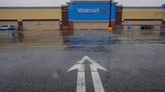 FILE PHOTO: An arrow in the parking lot points to a Walmart Superstore, temporarily closed by an order from the city after numerous employees tested positive for the coronavirus, which causes COVID-19, in Worcester, Massachusetts, U.S., April 30, 2020. RE