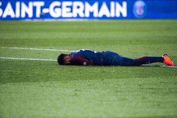 Neymar Jr reacts lying on the pitch after injury.