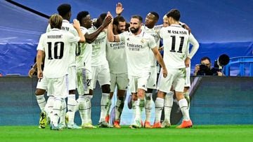 Real Madrid's Uruguayan midfielder Federico Valverde (R) celebrates with teammates after scoring his team's first goal during the UEFA Champions League, Group F, first leg football match between Real Madrid and RB Leipzig at the Santiago Bernabeu stadium in Madrid on September 14,