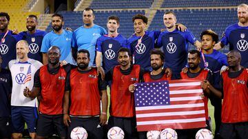 Soccer Football - FIFA World Cup Qatar 2022 - United States hold a welcome event with construction workers - Thani bin Jassim Stadium, Doha, Qatar - November 15, 2022 Christian Pulisic of the U.S. and teammates pose with players from a construction workers team REUTERS/Kai Pfaffenbach