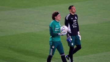 DOHA, QATAR - NOVEMBER 19: Guillermo Ochoa #13 and Rodolfo Cota #12 of Team Mexico walk on the pitch during a training session for Team Mexico at Al Khor Stadium on November 19, 2022 in Doha, Qatar. (Photo by Elsa/Getty Images)