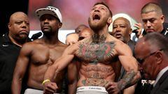 LAS VEGAS, NV - AUGUST 25: UFC lightweight champion Conor McGregor (R) screams after the face off with Floyd Mayweather Jr. during their official weigh-in at T-Mobile Arena on August 25, 2017 in Las Vegas, Nevada. The two will meet in a super welterweight