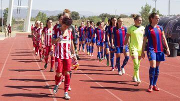 Barcelona Femení and Atlético Madrid Femenino stride out for today's Copa de la Reina final in Las Rozas.