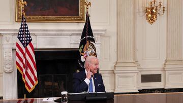 President Joe Biden listens to reporters shout questions while hosting a roundtable with CEOs of utilities to discuss the &#039;Build Back Better&#039; agenda, in the State Dining Room at the White House.
