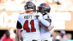 CHARLOTTE, NORTH CAROLINA - JANUARY 07: Ko Kieft #41 and Rachaad White #1 of the Tampa Bay Buccaneers embrace during the fourth quarter against the Carolina Panthers at Bank of America Stadium on January 07, 2024 in Charlotte, North Carolina.   Grant Halverson/Getty Images/AFP (Photo by GRANT HALVERSON / GETTY IMAGES NORTH AMERICA / Getty Images via AFP)