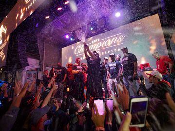 TORONTO, ON - JUNE 13: Toronto rapper Drake sprays the crowd with champaign as Toronto Raptors beat the Golden State Warriors in Game Six of the NBA Finals, during a viewing party in Jurassic Park outside of Scotiabank Arena on June 13, 2019 in Toronto, C