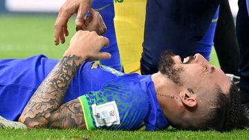 Brazil's defender #16 Alex Telles reacts after picking up an injury during the Qatar 2022 World Cup Group G football match between Cameroon and Brazil at the Lusail Stadium in Lusail, north of Doha on December 2, 2022. (Photo by Issouf SANOGO / AFP) (Photo by ISSOUF SANOGO/AFP via Getty Images)