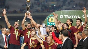 Esperance&#039;s Moez ben Cherifia and Haythem Jouini celebrate with the trophy after winning the CAF Champions League 