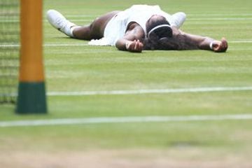 US player Serena Williams falls on the floor as she celebrates beating Germany's Angelique Kerber in the women's singles final on the thirteenth day of the 2016 Wimbledon Championships at The All England Lawn Tennis Club in Wimbledon, southwest London, on