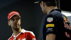 Sebastian Vettel of Germany and Ferrari looks at Max Verstappen of Netherlands