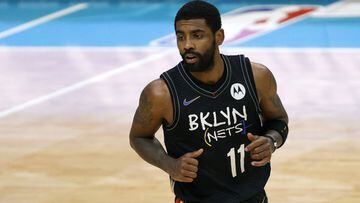 (FILES) In this file photo taken on December 27, 2020 Kyrie Irving #11 of the Brooklyn Nets runs the court during the fourth quarter of their game against the Charlotte Hornets at Spectrum Center in Charlotte, North Carolina. - Brooklyn point guard Kyrie 