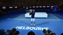 Novak Djokovic poses with the winner&#039;s trophy in Melbourne. 