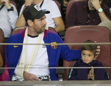 Messi watches on from the stands alongside son Thiago.