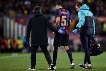 Barcelona's Spanish midfielder Sergio Busquets is escorted off pitch against Sevilla.
