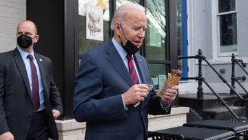 US President Joe Biden carries an ice cream cone as he leaves Jeni&#039;s Ice Cream in Washington, DC, on January 25, 2022.