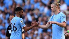 Manchester City's Algerian midfielder Riyad Mahrez (L) leaves the pitch after being substituted off for Manchester City's Norwegian striker Erling Haaland during the English Premier League football match between Manchester City and Chelsea at the Etihad Stadium in Manchester, north west England, on May 21, 2023. (Photo by Oli SCARFF / AFP) / RESTRICTED TO EDITORIAL USE. No use with unauthorized audio, video, data, fixture lists, club/league logos or 'live' services. Online in-match use limited to 120 images. An additional 40 images may be used in extra time. No video emulation. Social media in-match use limited to 120 images. An additional 40 images may be used in extra time. No use in betting publications, games or single club/league/player publications. / 