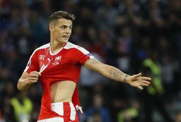 Xhaka has his shirt ripped after a challenge by France's Paul Pogba.