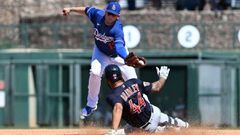 GLENDALE, ARIZONA - MARCH 23: Bobby Bradley #44 of the Cleveland Guardians safely slides into second base with an infield double as Max Muncy #13 of the Los Angeles Dodgers makes a leaping catch on a throw from Miguel Vargas #71 during the fourth inning o