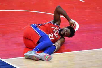 Mar 12, 2021; Washington, District of Columbia, USA; Philadelphia 76ers center Joel Embiid (21) reacts after suffering an apparent leg injury against the Washington Wizards during the third quarter at Capital One Arena. Mandatory Credit: Brad Mills-USA TO
