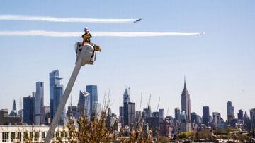 A PSE&amp;G utility worker watches the Navy&#039;s Blue Angels and the Air Force&#039;s Thunderbirds conduct &quot;a collaborative salute&quot; to honor those battling the COVID-19 pandemic with a flyover of New York and New Jersey, Tuesday, April 28, 202