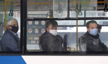 People wear protective masks look on in a bus in Ankara, Turkey.