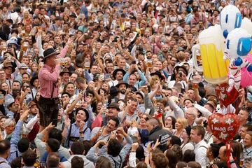 A visitor celebrates as he drinks one of the first mugs of beer during the official opening the world's largest beer festival, the 187th Oktoberfest in Munich, Germany, September 17, 2022. REUTERS/Michaela Rehle