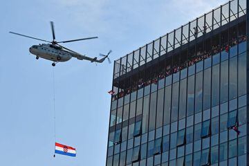 A Croatian Air Force helicopter flies over downtown Zagreb, where people gather to welcome their team, after reaching the final at the Russia 2018 World Cup, on July 16, 2018. / AFP PHOTO / Andrej ISAKOVIC