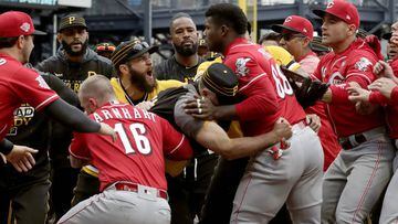 Cincinnati Reds&#039; Yasiel Puig (66) is restrained by Pittsburgh Pirates bench coach Tom Prince, in the middle of a bench clearing brawl during the fourth inning of a baseball game in Pittsburgh, Sunday, April 7, 2019. (AP Photo/Gene J. Puskar)