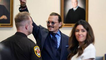 Actor Johnny Depp gestures to spectators in court after closing arguments at the Fairfax County Circuit Courthouse in Fairfax, Virginia, on May 27, 2022. - Actor Johnny Depp is suing ex-wife Amber Heard for libel after she wrote an op-ed piece in The Washington Post in 2018 referring to herself as a public figure representing domestic abuse. (Photo by Steve Helber / POOL / AFP) (Photo by STEVE HELBER/POOL/AFP via Getty Images)