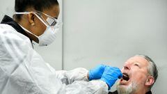 FILE PHOTO: A member of medical staff takes a coronavirus test sample of a man in Bergschenhoek, Netherlands January 13, 2021. REUTERS/Piroschka van de Wouw/File Photo