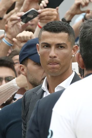 Portuguese attacker Cristiano Ronaldo looks on as he walks out the Juventus medical center at the Alliance stadium in Turin on July 16, 2018 to greet supporters.