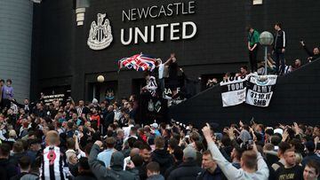 Newcastle United supporters celebrate outside St James' Park after the sale of the football club to a Saudi-led consortium was confirmed in 2021.