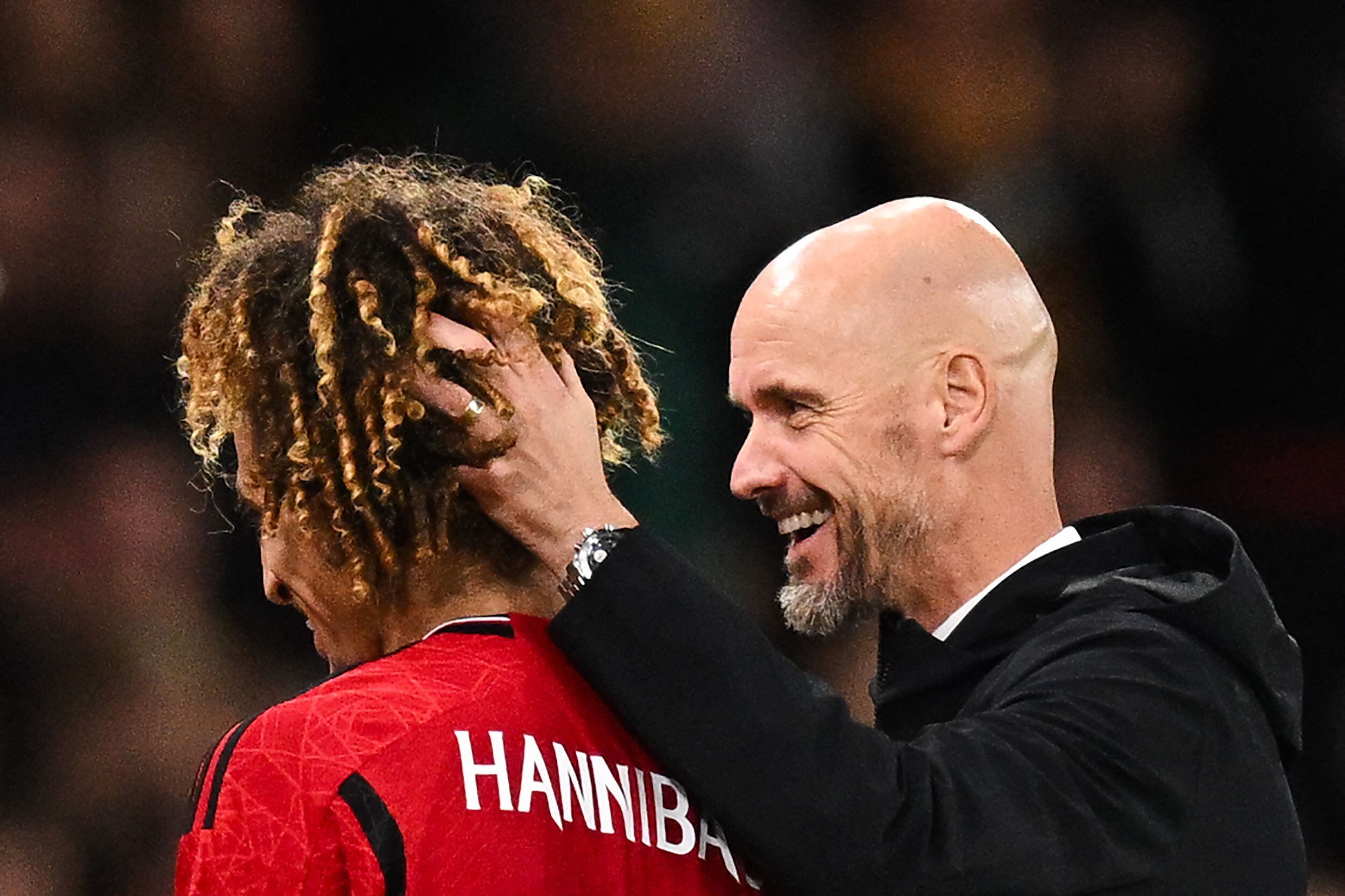 Manchester United's Dutch manager Erik ten Hag congratulates Manchester United's Tunisian midfielder #46 Hannibal Mejbri as he leaves the pitch during the English League Cup third round football match between Manchester United and Crystal Palace at Old Trafford in Manchester, north west England, on September 26, 2023. (Photo by Oli SCARFF / AFP) / RESTRICTED TO EDITORIAL USE. No use with unauthorized audio, video, data, fixture lists, club/league logos or 'live' services. Online in-match use limited to 120 images. An additional 40 images may be used in extra time. No video emulation. Social media in-match use limited to 120 images. An additional 40 images may be used in extra time. No use in betting publications, games or single club/league/player publications. / 