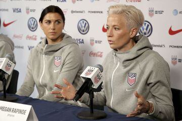 FILE - United States women's national soccer team members Alex Morgan, left, listens as teammate Megan Rapinoe speak to reporters during a news conference in New York, Friday, May 24, 2019.