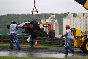 Romain Grosjean's car leaves by crane.