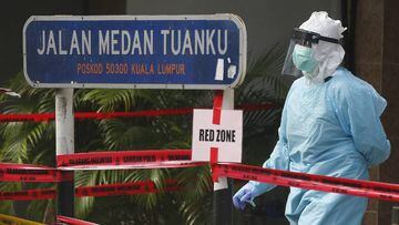 A hospital health worker wears protective gear at the red zone in Kuala Lumpur. 