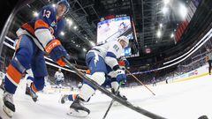 Mathew Barzal #13 of the New York Islanders and Erik Cernak #81 of the Tampa Bay Lightning battle for the puck