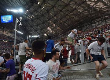 Supporters jump over barriers to escape from clashes in the stands of Stade Vélodrome in Marseille.