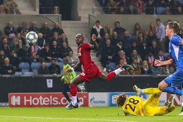 Nice finish: Liverpool's Sadio Mané dinks one over the keeper in this week's game against Genk.