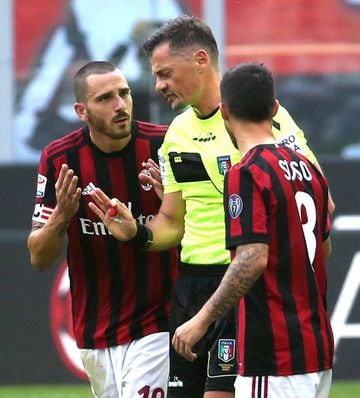 AC Milan defender Leonardo Bonucciremonstrates with Italian referee Piero Giacomelli on receiving his red card.