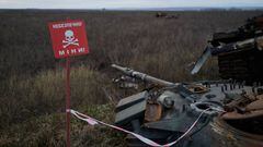 IZYUM, UKRAINE - DECEMBER 22: A warning sign for mines is seen near a Russian tank hit by an anti-tank missile on December 22, 2022 in Izyum, Ukraine. (Photo by Pierre Crom/Getty Images)
