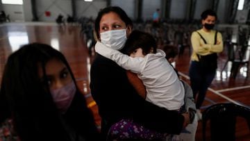 Jade Velozo, 4, is held by her mother Claudia Reinoso, before receiving a dose of the Sinopharm vaccine against the coronavirus disease (COVID-19) at a vaccination centre in Buenos Aires, Argentina October 15, 2021. REUTERS/Agustin Marcarian