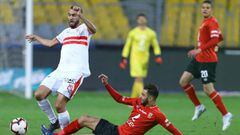Zamalek&#039;s defender Mahmoud Hamdy (L) is tackled by Al Ahly&#039;s midfielder Amr El Solia (C) during the Egyptian Premier League football match between Zamalek and Al Ahly at the Borg El Arab Stadium, near Alexandria on March 30, 2019. (Photo by Tare